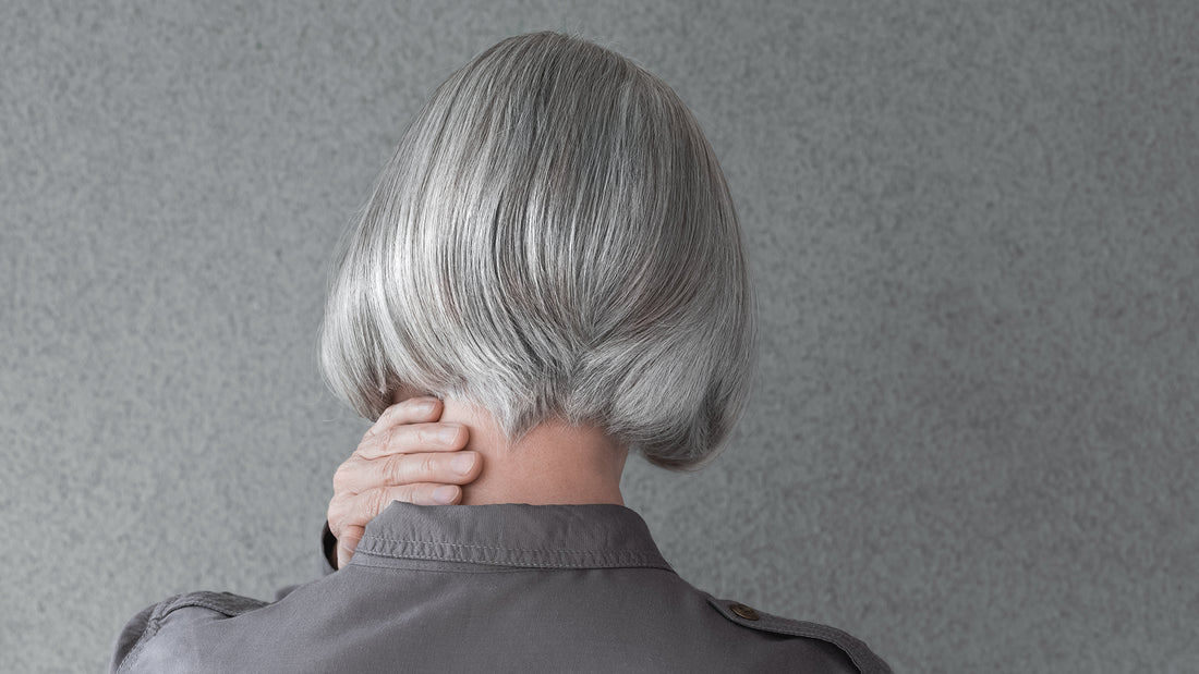 woman with long hair pulling it to the side 